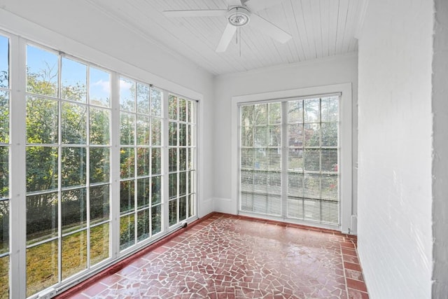 unfurnished sunroom with ceiling fan and plenty of natural light