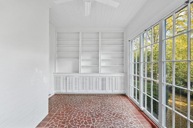 unfurnished sunroom featuring ceiling fan and wooden ceiling