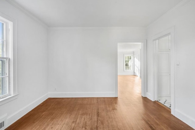 spare room featuring hardwood / wood-style floors and ornamental molding