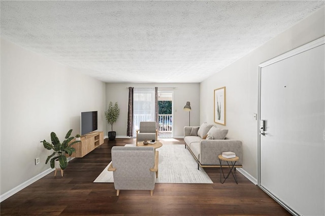 living room with dark hardwood / wood-style flooring and a textured ceiling