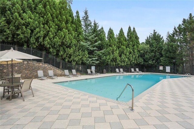 view of swimming pool featuring a patio area