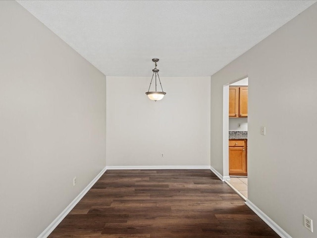 unfurnished dining area with dark hardwood / wood-style floors