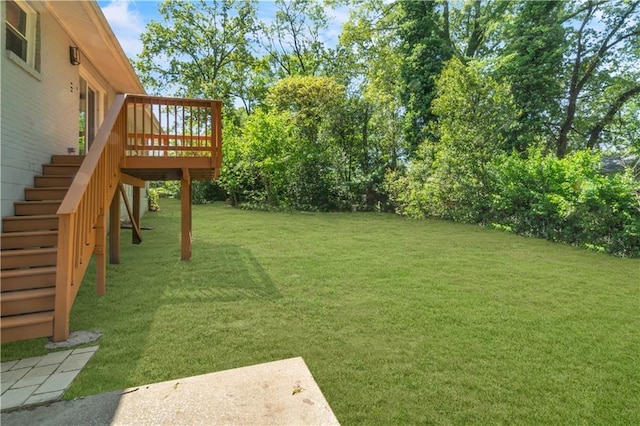 view of yard with a deck and stairway