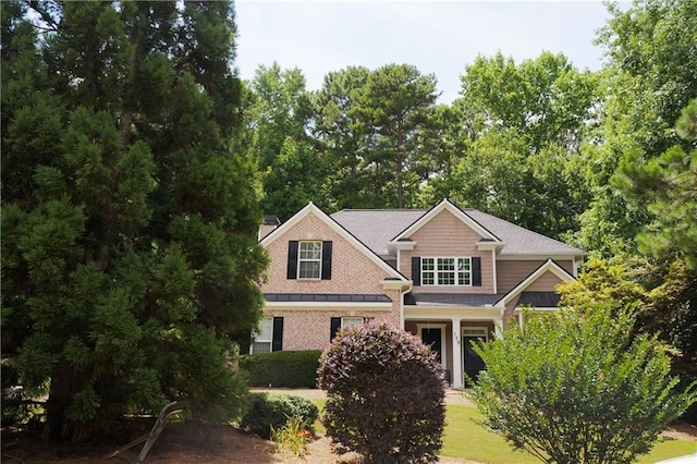 view of front of property with brick siding and a chimney