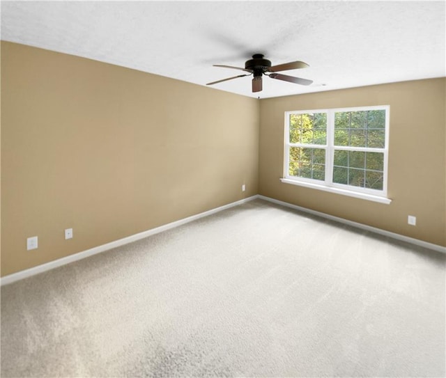 unfurnished room featuring ceiling fan and carpet flooring