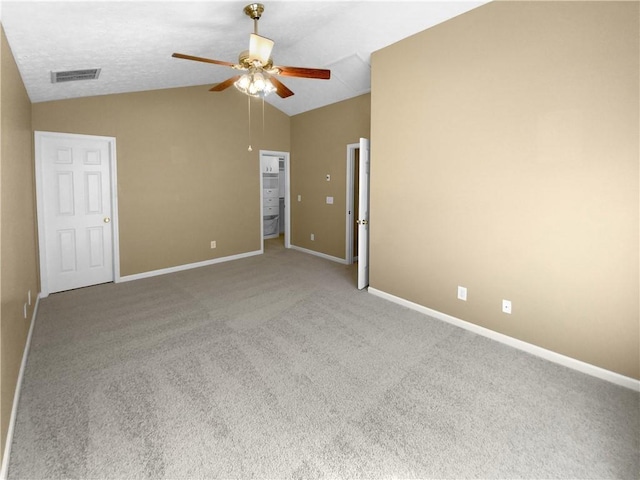 carpeted empty room featuring vaulted ceiling and ceiling fan