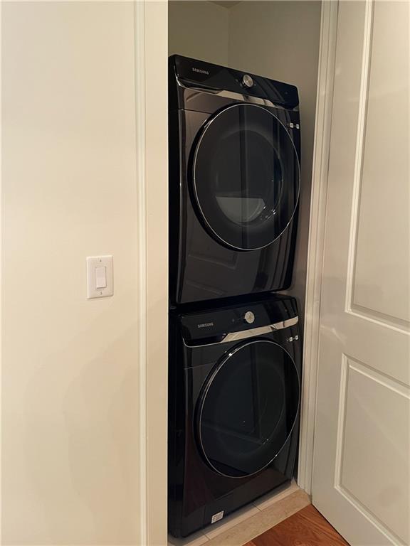 3630 Peachtree Rd NE Unit 2305, Atlanta, GA 30326 - laundry area with stacked washer / dryer and light wood-style flooring