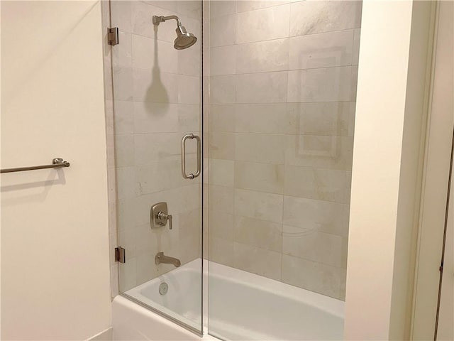 bathroom with shower / bath combination with glass door