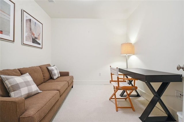 carpeted home office featuring baseboards