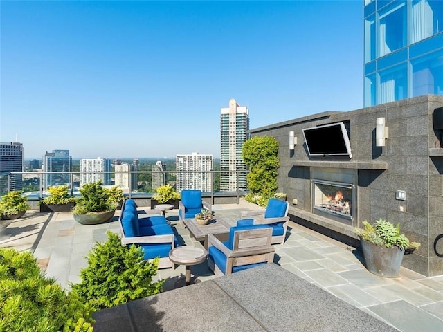 view of patio / terrace featuring an outdoor living space with a fireplace