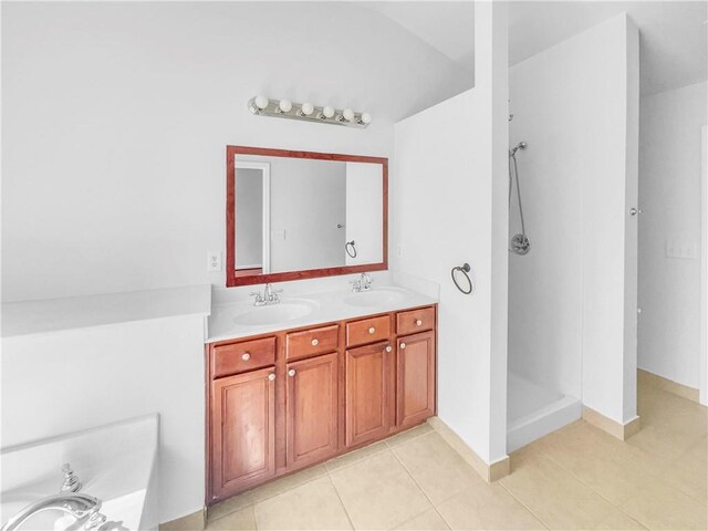 bathroom featuring tile patterned flooring, walk in shower, and a sink