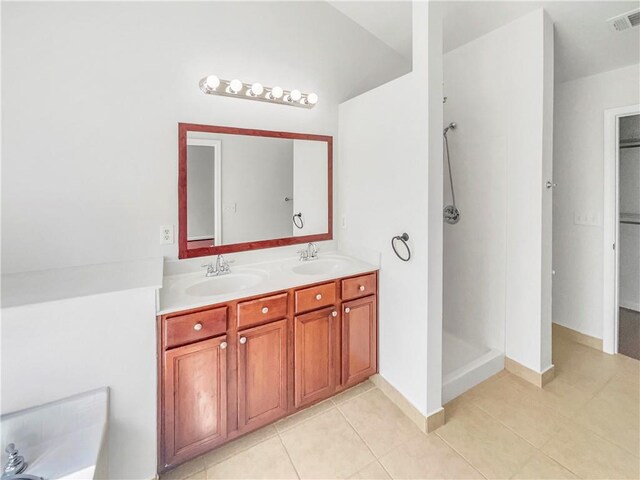 bathroom with double vanity, visible vents, a walk in shower, and a sink