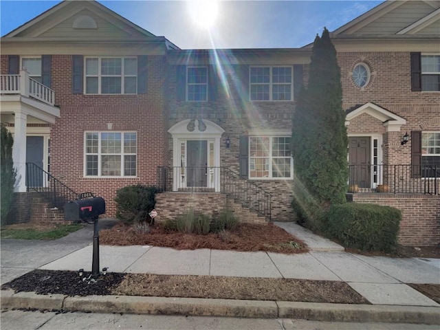 townhome / multi-family property with brick siding
