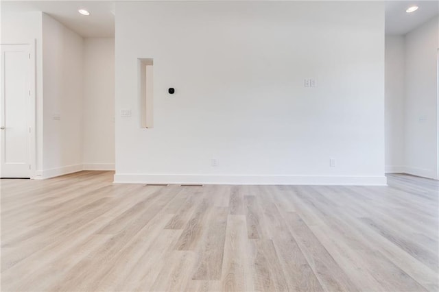 unfurnished room with light wood-type flooring