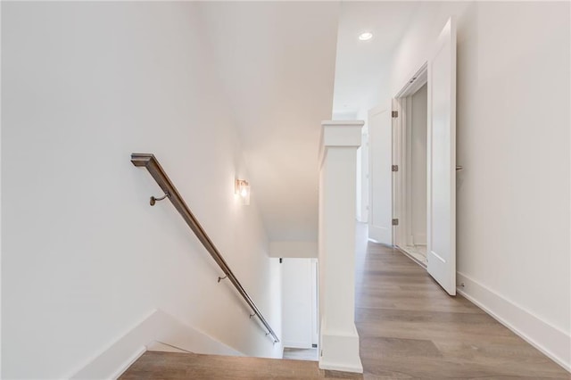 stairs featuring hardwood / wood-style flooring