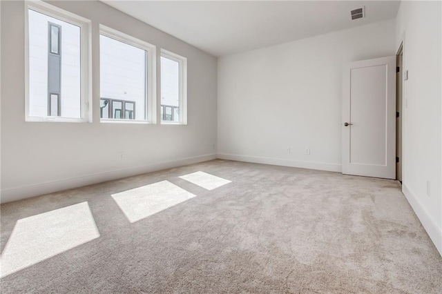 empty room featuring light colored carpet