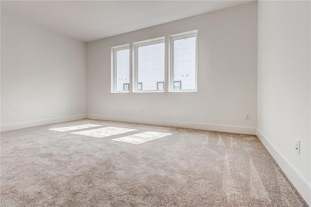 empty room featuring light colored carpet