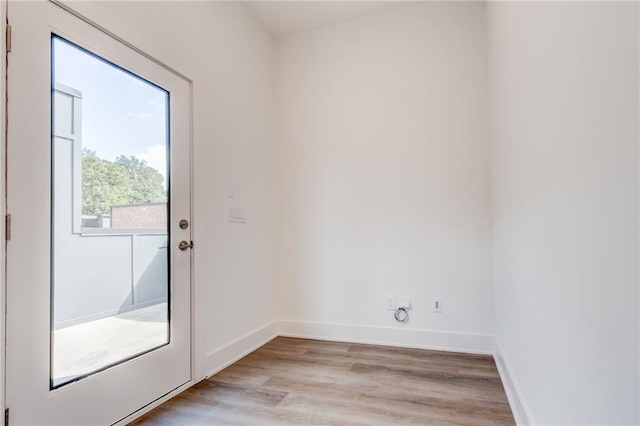 doorway to outside with light wood-type flooring