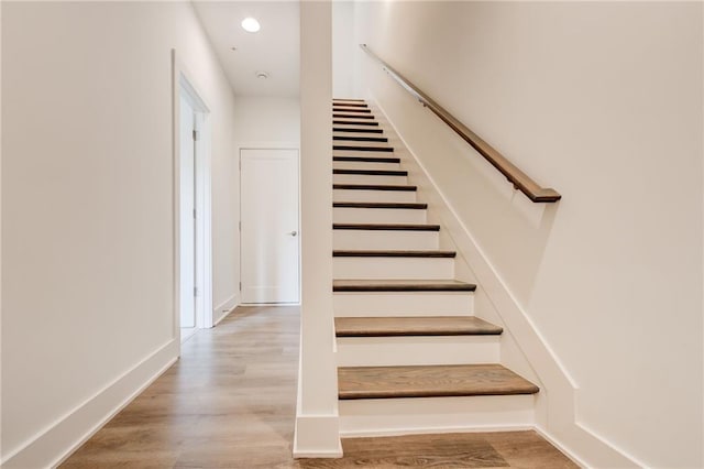 stairs with hardwood / wood-style floors