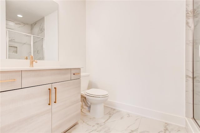 bathroom featuring a shower with door, vanity, and toilet