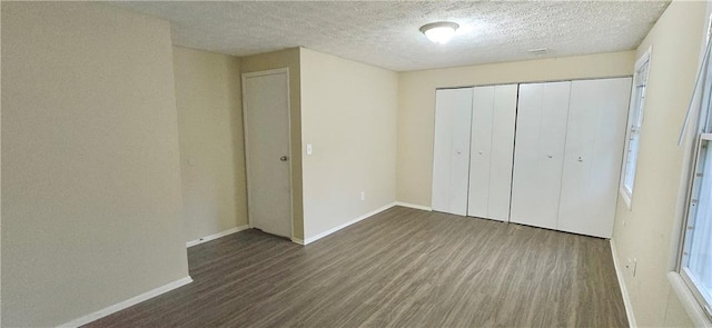 5595 Marbut Rd, Lithonia, GA 30058 - unfurnished bedroom with wood finished floors, a closet, and a textured ceiling