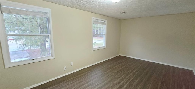 5595 Marbut Rd, Lithonia, GA 30058 - empty room featuring dark wood-style flooring and a textured ceiling