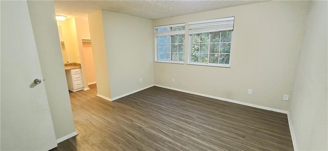 5595 Marbut Rd, Lithonia, GA 30058 - unfurnished room featuring dark wood finished floors and a textured ceiling