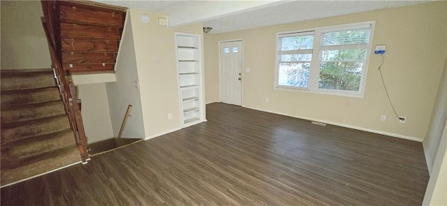 5595 Marbut Rd, Lithonia, GA 30058 - unfurnished living room featuring wood finished floors, built in features, and stairway