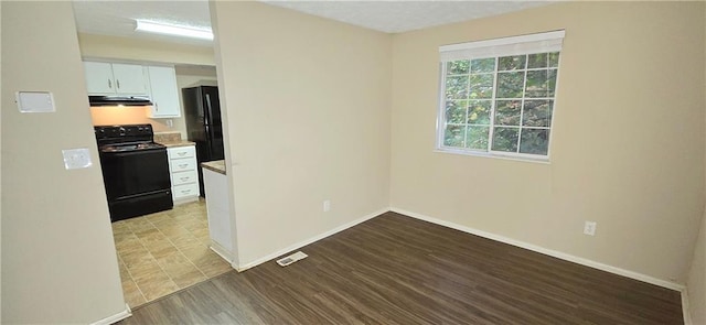 5595 Marbut Rd, Lithonia, GA 30058 - spare room with baseboards and wood finished floors