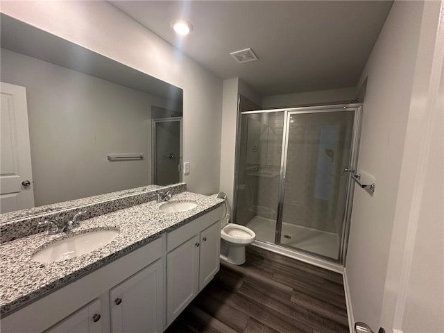 8664 Webb Rd, Riverdale, GA 30274 - full bath with wood finished floors, a shower stall, double vanity, and toilet
