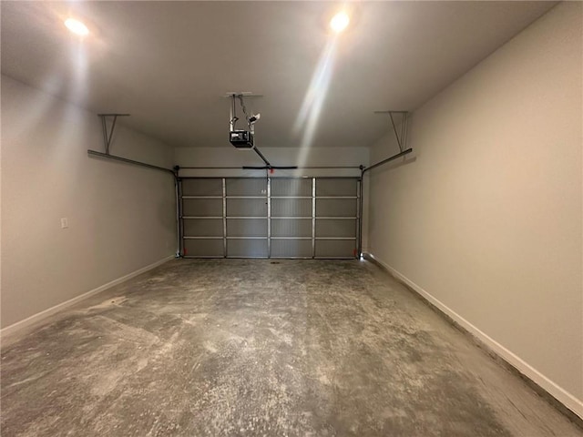 8664 Webb Rd, Riverdale, GA 30274 - garage featuring a garage door opener and baseboards