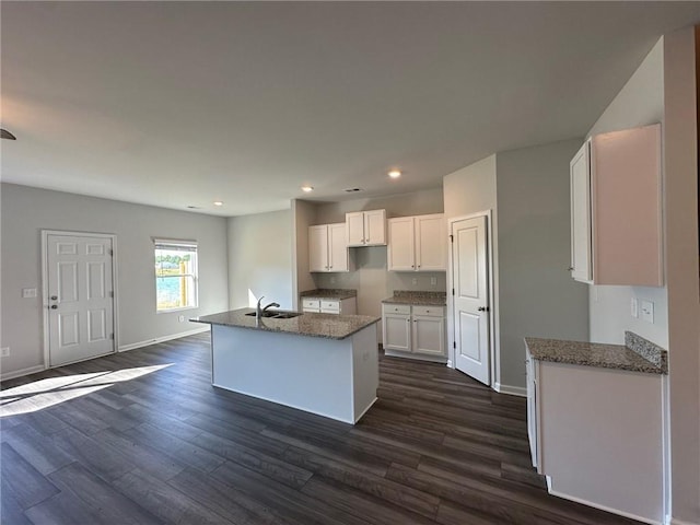 8664 Webb Rd, Riverdale, GA 30274 - kitchen featuring a sink, white cabinetry, dark wood-type flooring, dark stone countertops, and recessed lighting