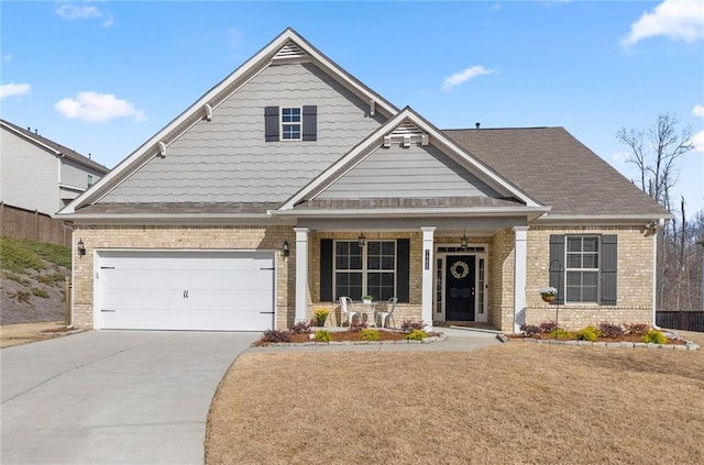 craftsman inspired home featuring brick siding, a porch, and driveway