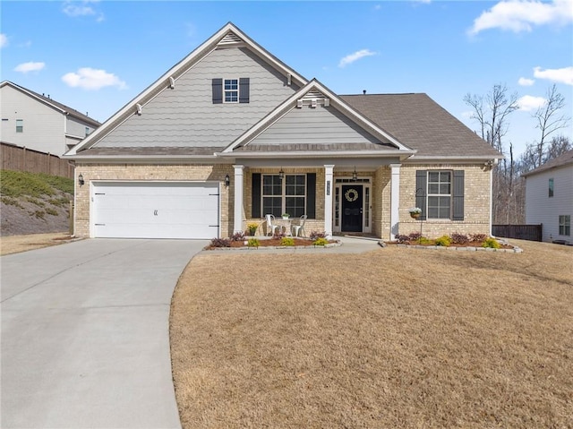 craftsman-style home featuring brick siding, covered porch, concrete driveway, and a front yard