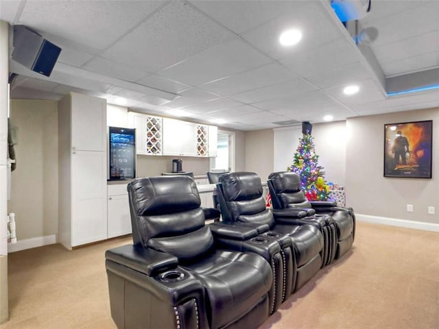 cinema featuring light carpet and a drop ceiling