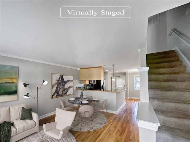 living room with light hardwood / wood-style flooring and ornamental molding