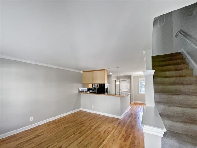 unfurnished living room with wood-type flooring and ornamental molding