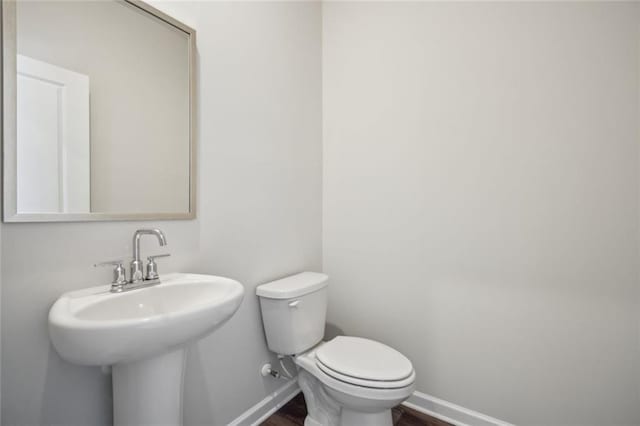 164 Long Leaf St, Dawsonville, GA 30534 - bathroom featuring toilet, baseboards, wood finished floors, and a sink
