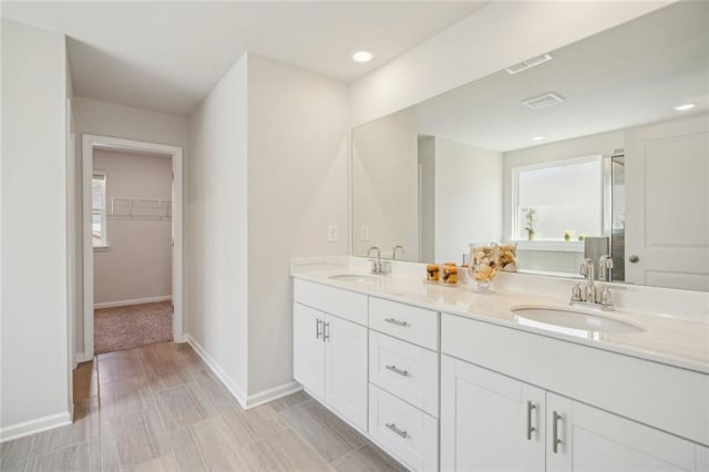164 Long Leaf St, Dawsonville, GA 30534 - bathroom with a sink, a spacious closet, baseboards, and double vanity