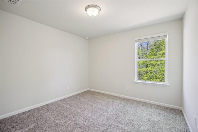 164 Long Leaf St, Dawsonville, GA 30534 - spare room featuring visible vents, baseboards, and carpet