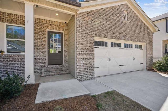 164 Long Leaf St, Dawsonville, GA 30534 - view of exterior entry with brick siding, driveway, and a garage