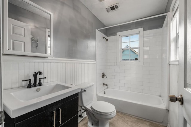 full bathroom with vanity, toilet, and tiled shower / bath combo