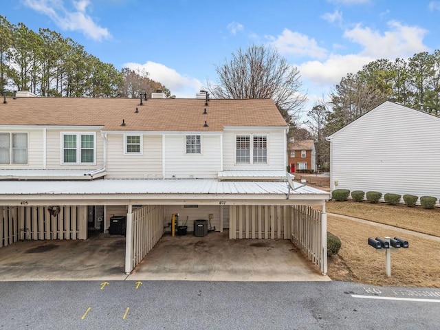 rear view of property featuring central AC