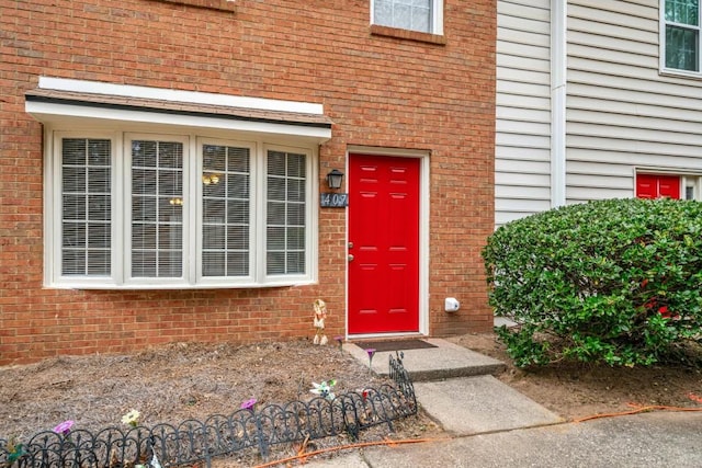 property entrance with brick siding