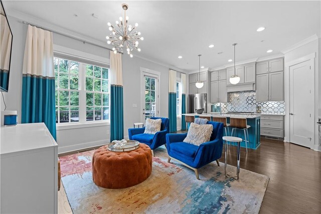 living area featuring baseboards, dark wood-style floors, crown molding, a chandelier, and recessed lighting