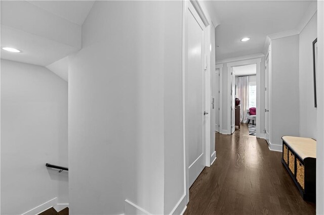 hall featuring an upstairs landing, baseboards, dark wood-type flooring, and recessed lighting