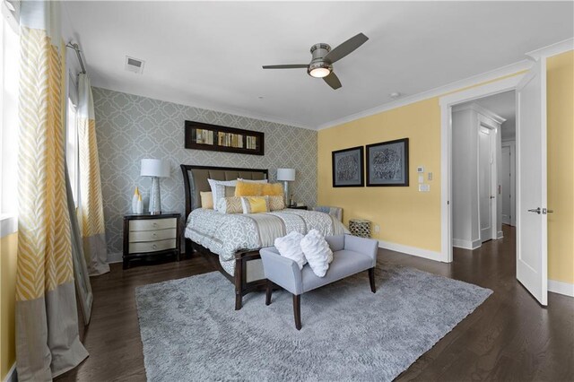 bedroom with wallpapered walls, visible vents, an accent wall, and baseboards