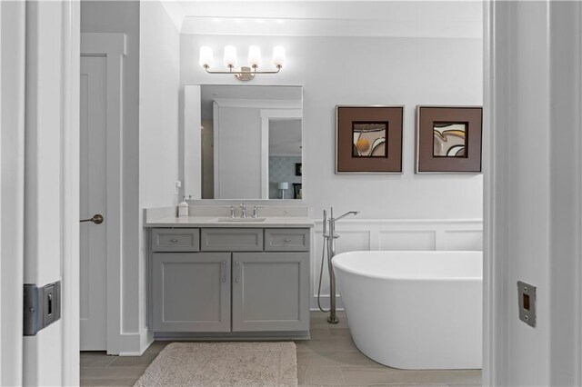 bathroom featuring a soaking tub and vanity