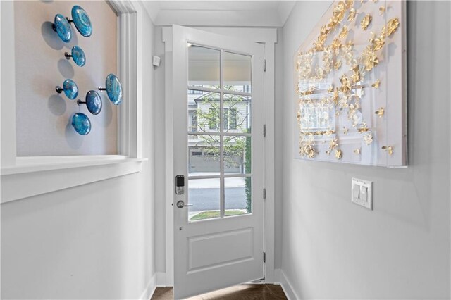 doorway featuring baseboards