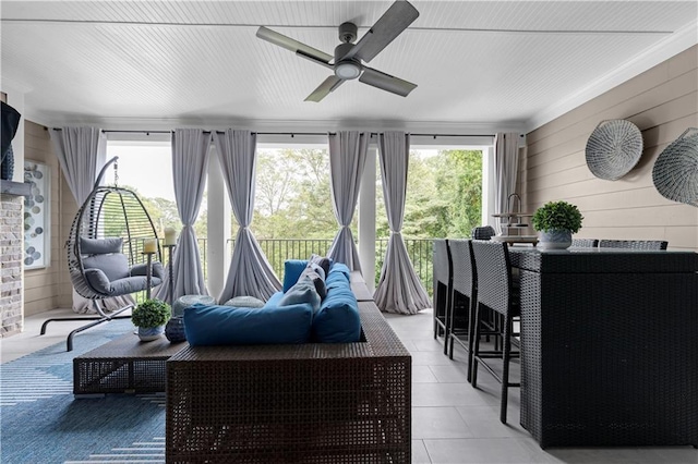 sunroom with a healthy amount of sunlight and a ceiling fan